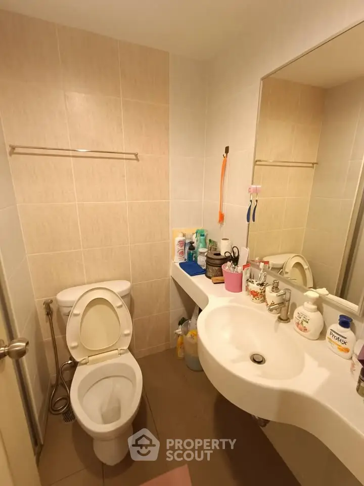 Compact bathroom with modern fixtures and ample storage space