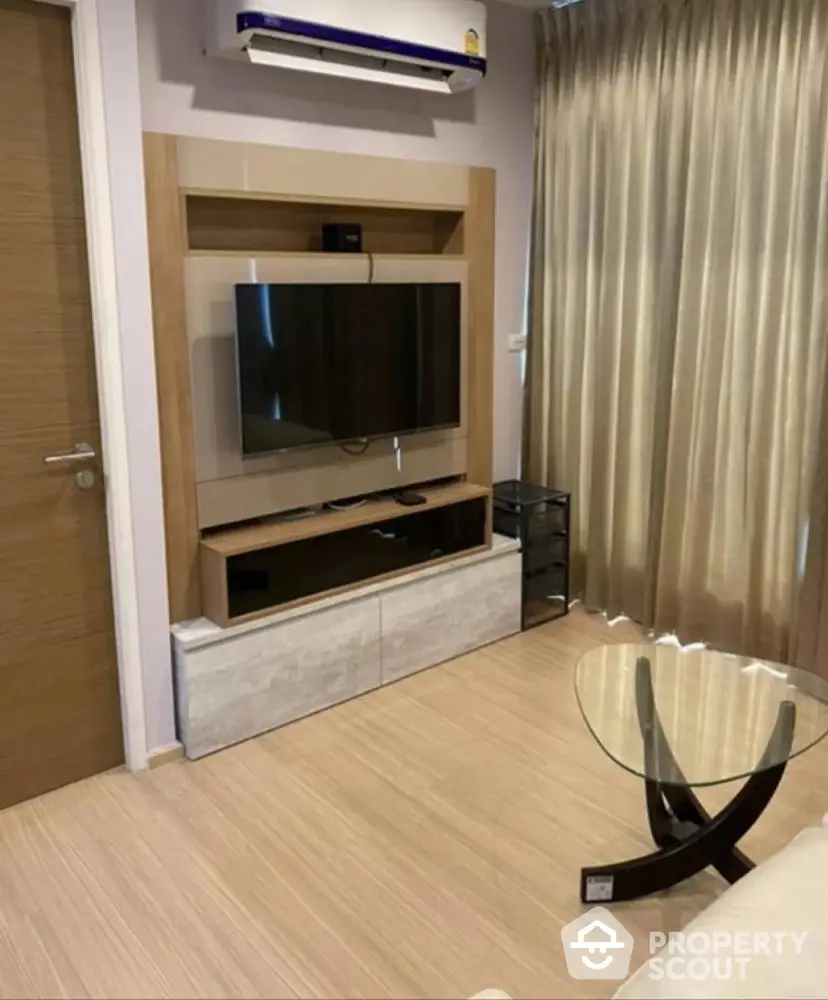 Modern living room with sleek TV unit and stylish glass coffee table