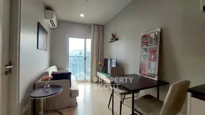 Modern living room with balcony view, stylish decor, and natural light in a cozy apartment.