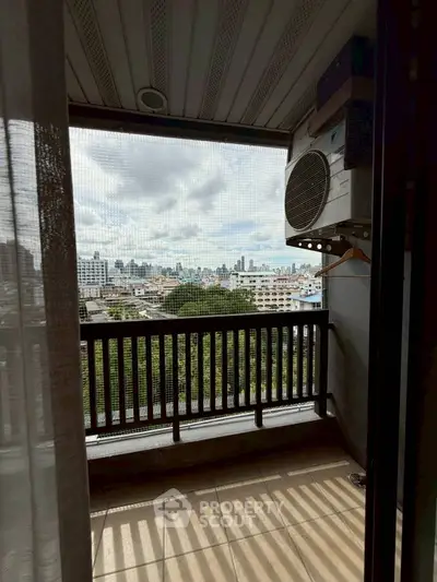 Charming balcony with city skyline view, perfect for relaxation and enjoying urban scenery.