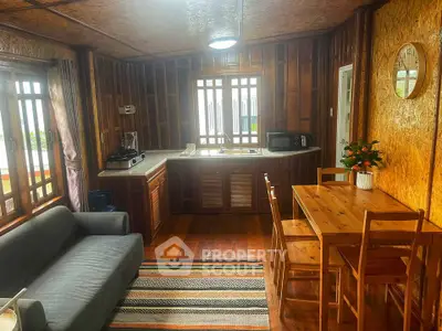 Cozy wooden interior with kitchen and dining area, featuring natural light and modern amenities.