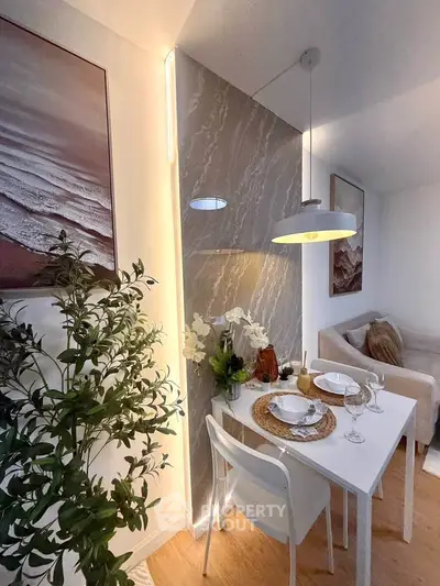 Chic dining area with modern decor and cozy seating in stylish apartment.