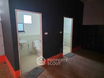Spacious interior with dual bathroom access, ideal for shared living or commercial use.