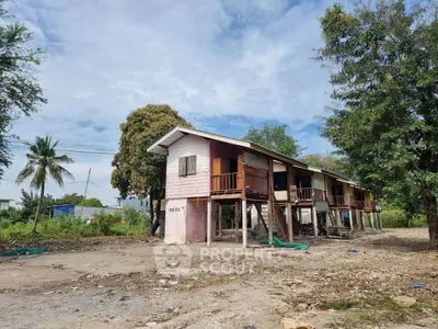 Charming rustic wooden stilt house surrounded by lush greenery, perfect for nature lovers seeking tranquility.