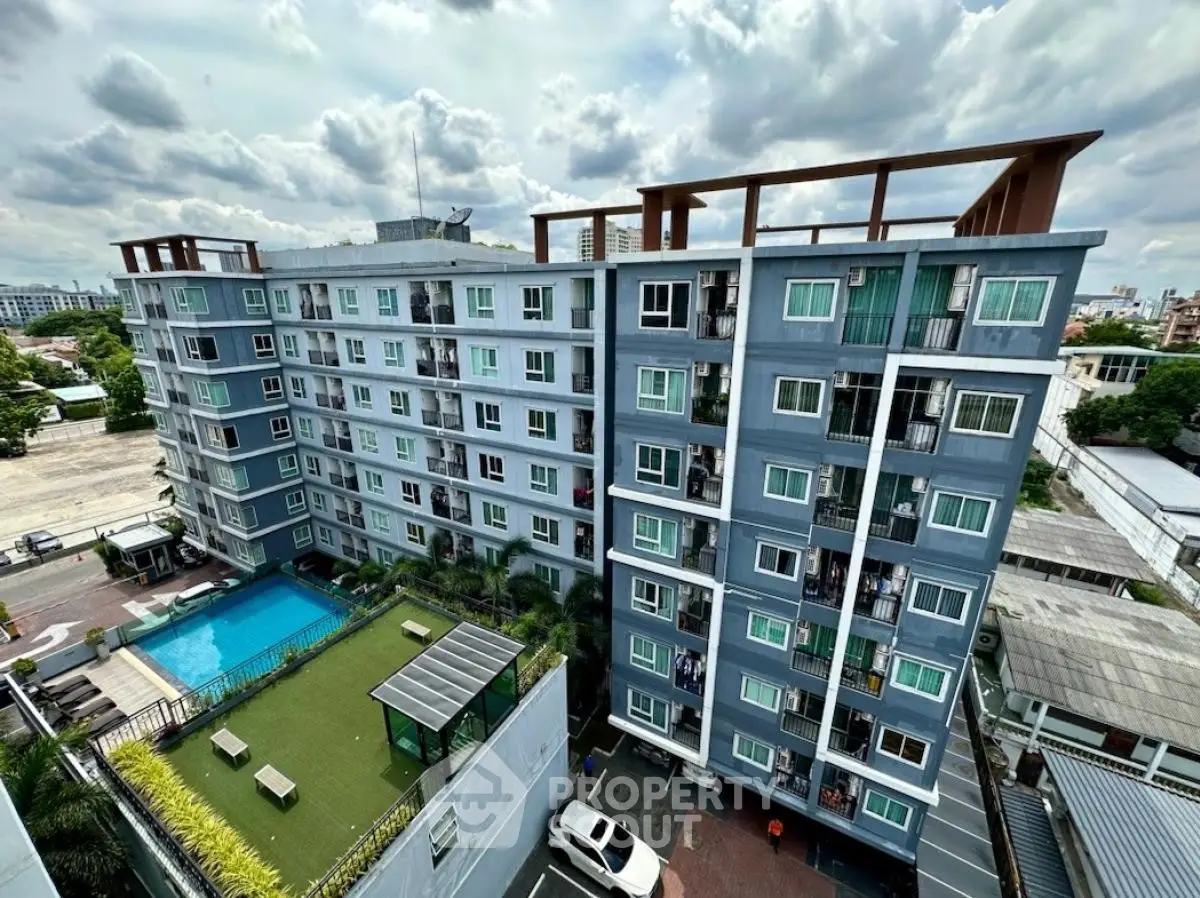 Modern apartment building with pool and rooftop garden, offering urban living with great amenities.