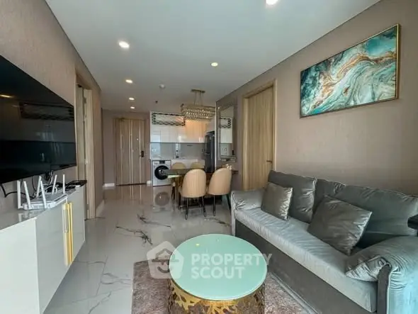 Modern living room with sleek furniture and open kitchen layout