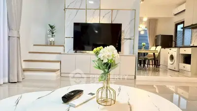 Modern living room with marble accents and open kitchen layout