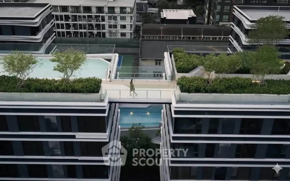 Stunning rooftop garden and pool connecting modern apartment buildings