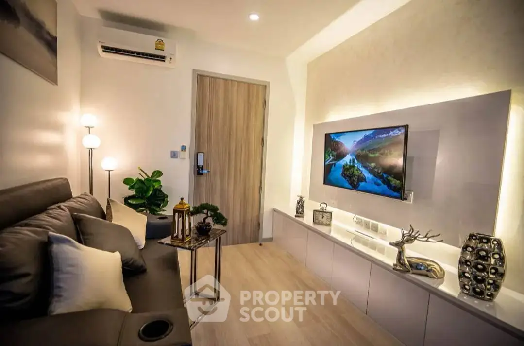 Modern living room with sleek decor and wall-mounted TV, perfect for relaxation and entertainment.
