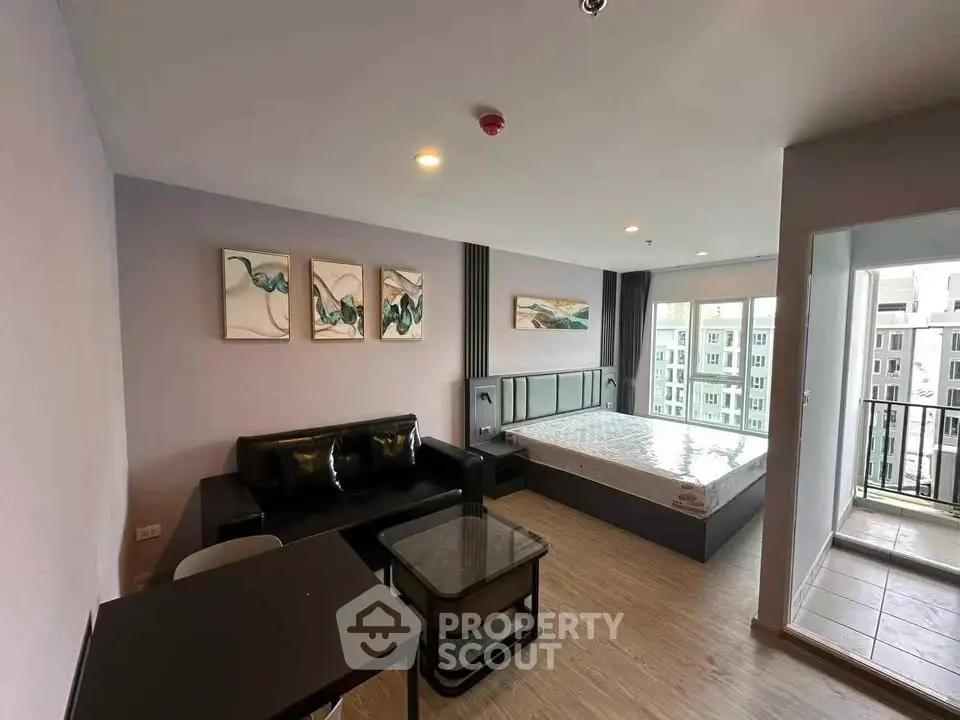 Modern studio apartment with stylish decor and balcony view