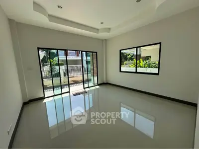 Spacious empty room with large windows and glossy floor, perfect for customization.