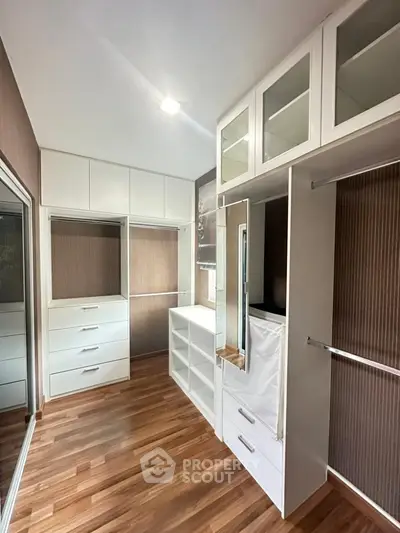 Spacious walk-in closet with modern design and ample storage solutions