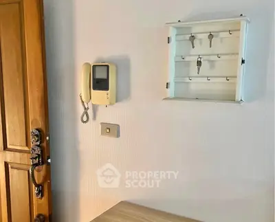 Charming entryway with wooden door and key holder, perfect for organizing your home essentials.