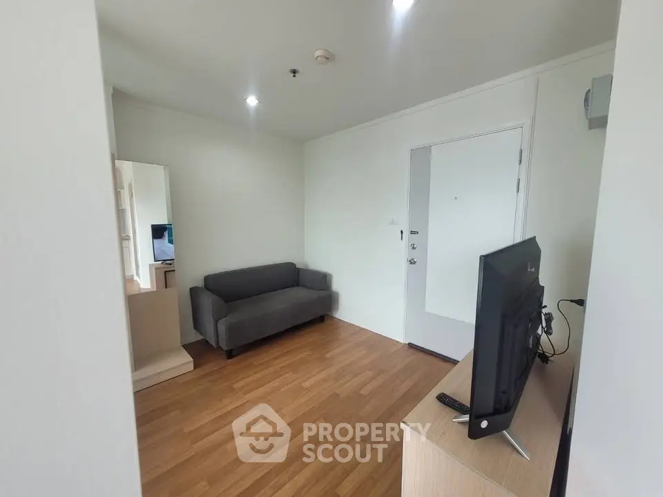 Cozy living room with wooden flooring and modern furniture in a stylish apartment.