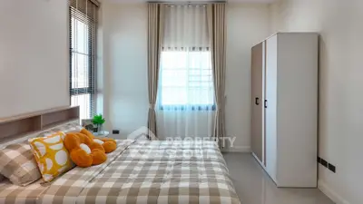 Cozy bedroom with stylish decor and ample natural light