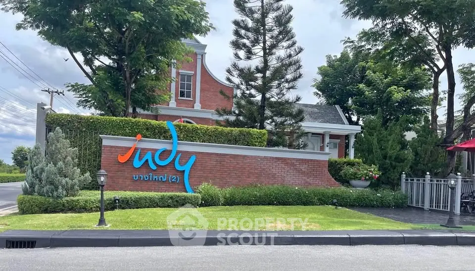 Charming residential entrance with lush greenery and elegant brick facade