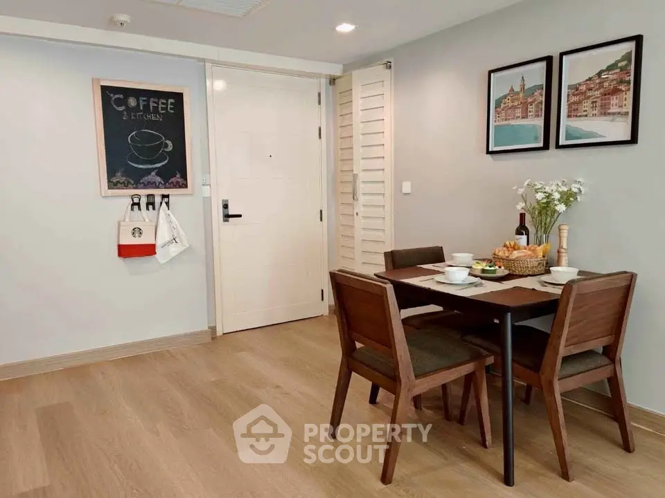 Charming dining area with wooden furniture and stylish decor in modern apartment.