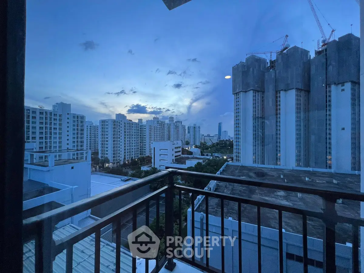 Stunning cityscape view from a high-rise balcony at dusk, showcasing urban living.