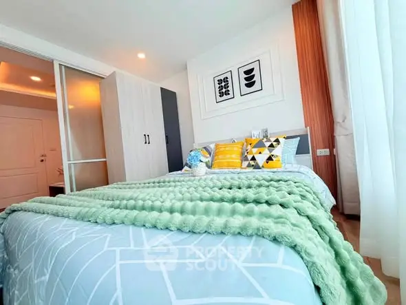 Modern bedroom with stylish decor and cozy bedding in a bright apartment.