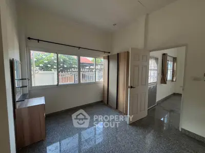 Spacious room with large windows and glossy floor in a modern home