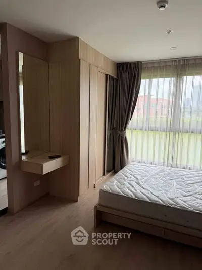 Modern bedroom with large windows and wooden furniture in a stylish apartment.