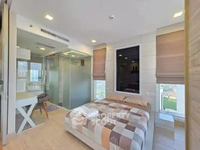 Modern bedroom with city view, featuring glass-walled study area and stylish decor.