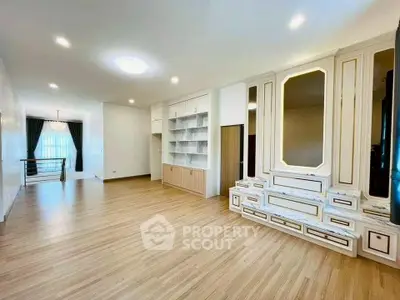 Spacious living room with elegant built-in shelves and modern lighting