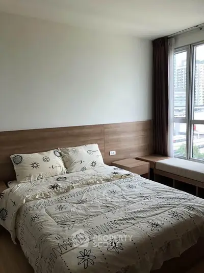 Cozy bedroom with large window and modern decor in urban apartment