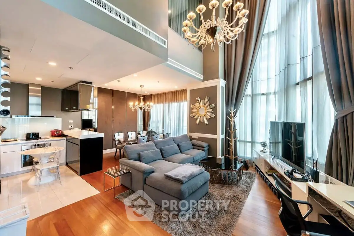 Luxurious modern living room with high ceilings and elegant chandeliers in a stylish apartment.
