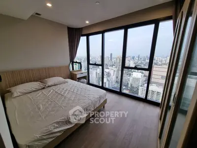 Luxurious bedroom with panoramic city view in modern high-rise apartment