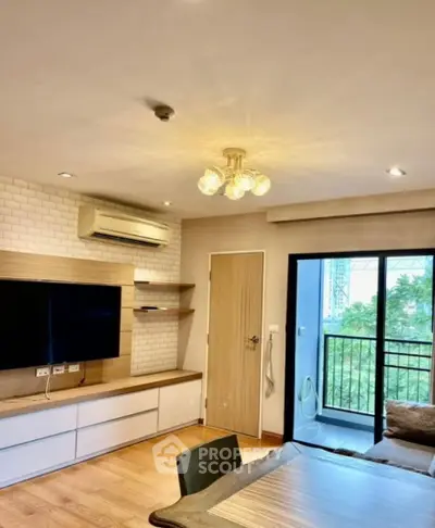 Modern living room with balcony view, featuring stylish lighting and air conditioning.
