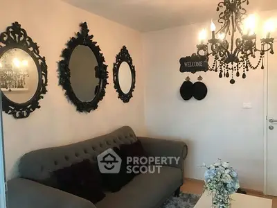 Charming living room with elegant chandelier and vintage mirrors.