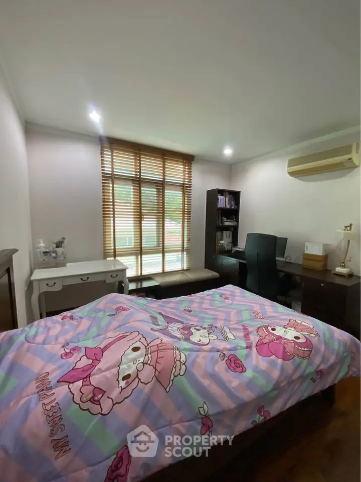 Cozy bedroom with vibrant decor and ample natural light