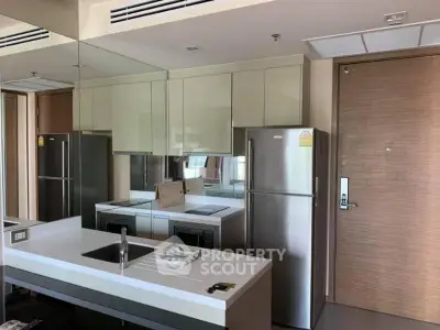 Modern kitchen with sleek cabinetry and stainless steel appliances in a stylish apartment.