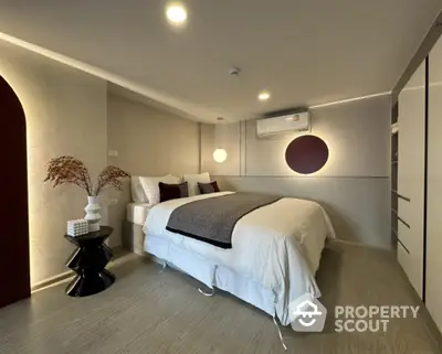 Modern bedroom with stylish decor and ambient lighting