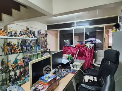 Spacious study room with modern desk and vibrant collectibles display.