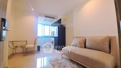 Modern living room with cozy sofa and compact kitchen area