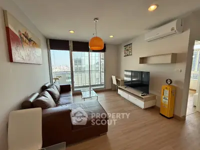 Modern living room with city view, stylish furniture, and natural light