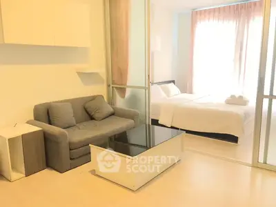 Modern studio apartment with cozy living area and bright bedroom