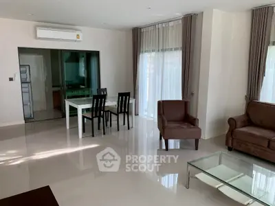 Spacious modern living room with elegant furniture and large windows