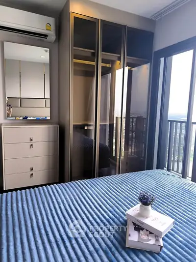 Modern bedroom with sleek wardrobe and balcony view, perfect for urban living.