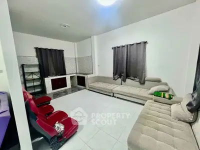 Spacious living room with modern furniture and tiled flooring