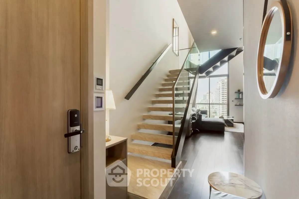 Modern duplex apartment with stylish staircase and cozy living area