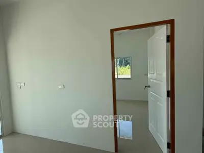 Minimalist interior with open door and window view in modern home