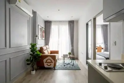 Modern living room with stylish decor and natural light in a contemporary apartment.
