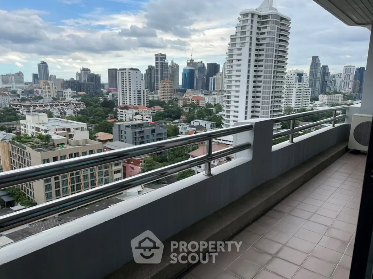 Stunning cityscape view from a spacious balcony in a high-rise apartment.