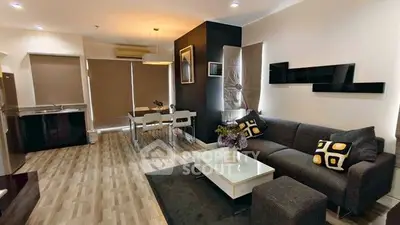 Modern living room with stylish decor and open dining area in a cozy apartment.