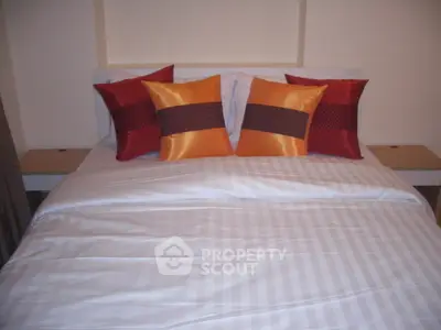 Cozy bedroom with stylish pillows and modern decor