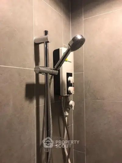 Modern bathroom with sleek shower and gray tiled walls