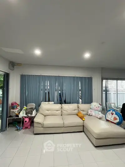 Spacious living room with modern decor and plush seating, perfect for family gatherings.